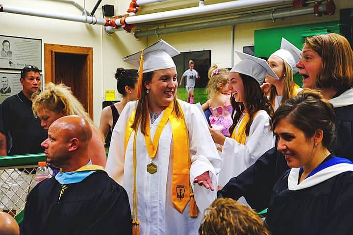 [CREDIT: Lauren Kasz] Valedictorian Alexandrea Pouliot and Salutatorian Chelsea Lavallee share a laugh before the processional kicks off at CCRI during the Pilgrim High School Class of 2017 graduation.