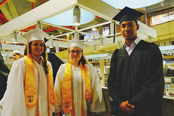[CREDIT: Lauren Kasz] Avonlea Gauthier, Tamar Gershman and Jadin Genao prepare to march toward their diplomas at CCRI during the Pilgrim High School Class of 2017 graduation.
