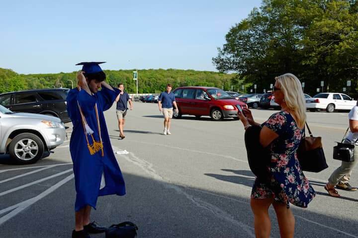 [CREDIT: Rob Borkowski] Linda Sundstrom takes a photo of her graduate son Jonathan, at CCRI Tuesday. 