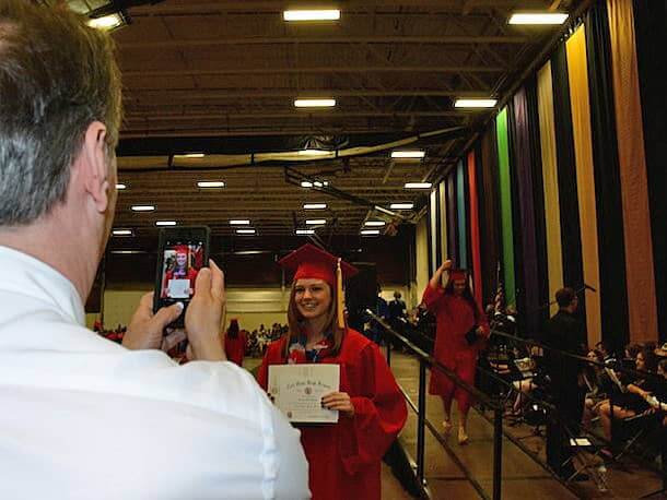 [CREDIT: Rob Borkowski] Bill Weaver catches a photo of his just-graduated daughter, Veronica.