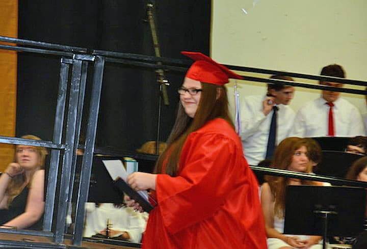 [CREDIT: Rob Borkowski] Aubra Palazzo, new graduate, returns to her seat, diploma in hand.