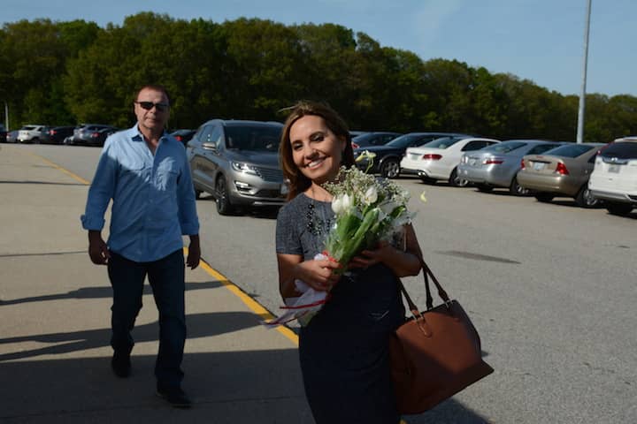 [CREDIT: Rob Borkowski] Ana Costa carried a bouquet of flowers for her graduate daughter, Victoria.at CCRI Tuesday. 