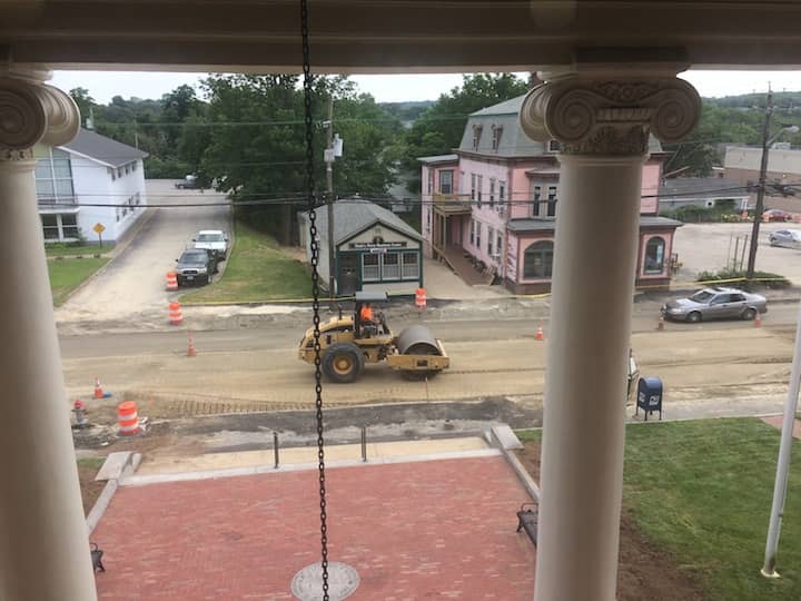 [CREDIT: Rob Borkowski] A road roller packs down one lane of Post Road in front of City Hall, shaking the building.