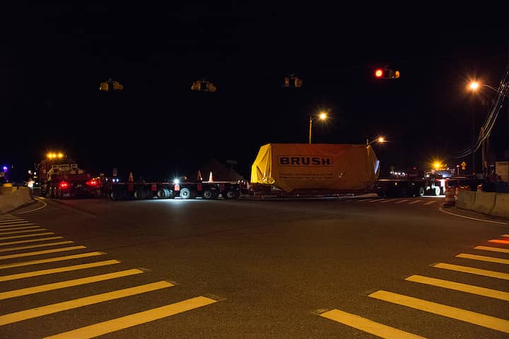 [PHOTO CREDTI: Mary Carlos] Bay Crane's hauler pulls a 161-ton generator through the intersection of Rte. 102 and Flat River Road in Coventry.