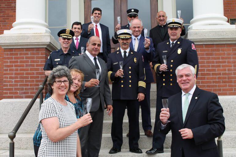 [CREDIT: Mayor Scott Avedisian] Pictured celebrating Providenc College's 100th anniversary are local alumni at Warwick City Hall Tuesday: Lynn Fitzsimmons Owens and Lynda Ortiz of the Warwick Sewer Authority, Council President Joseph Solomon, Mayor Scott Avedisian, Police Chief Colonel Stephen McCartney, Assistant Fire Chief James Kenney, Fire Chief James McLaughlin, City Controller Ken Alfano, Assistant City Solicitor and Prosecutor Kerry Rafanelli, State Representative Jospeh Solomon, Jr., Fire Captain Marcel Fontenault, and The Reverend Robert L. Marciano, Police and Fire Department Chaplain.  