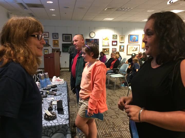 [CREDIT: Rob Borkowski] From left, Stacie Sullivan of Coventry speaks with Dale Belluscio at Warwick Public Library's Haunted History presentation Wednesday.