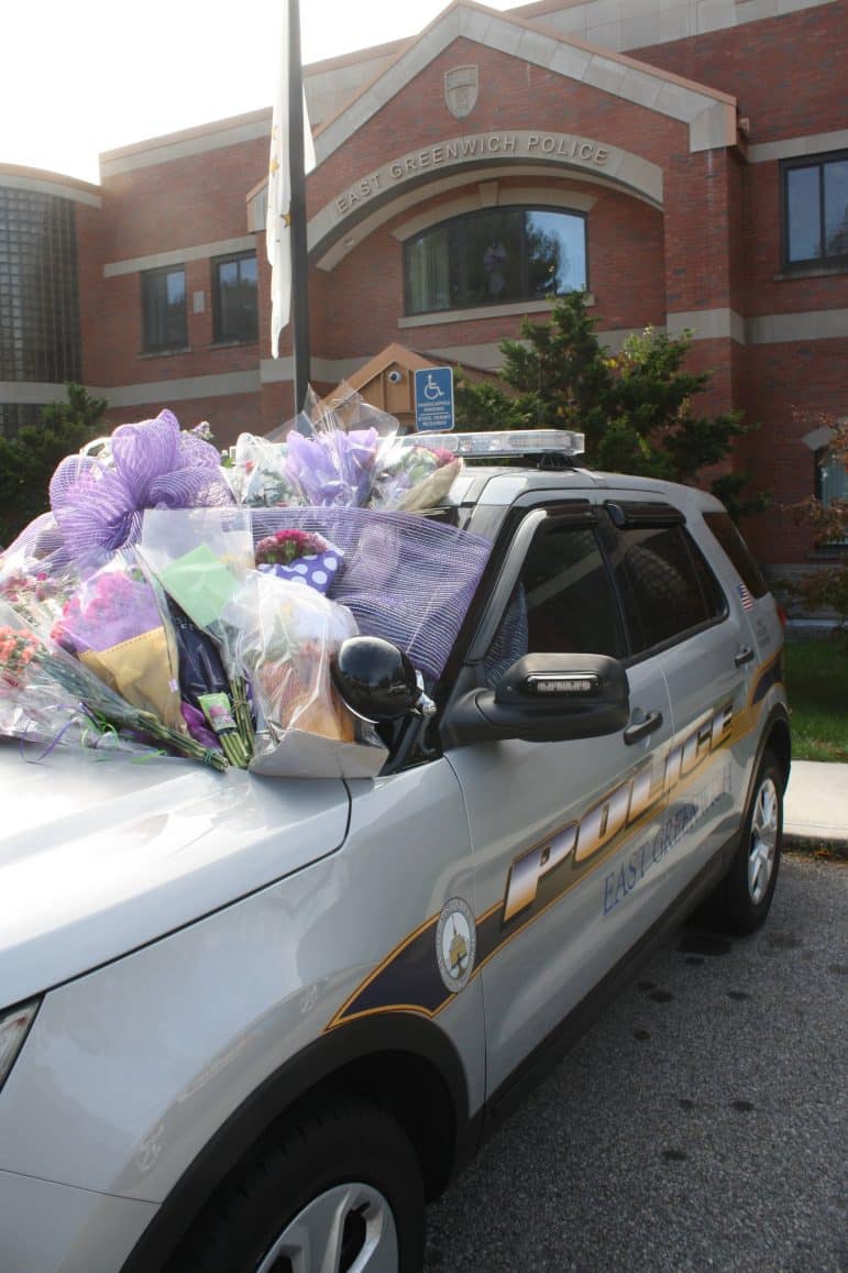 [CREDIT: Beth Hurd] Chief Cirella's patrol car is adorned with bouquets of flowers and sympathy cards for his family following the recent death of his daughter Gianna Cirella.