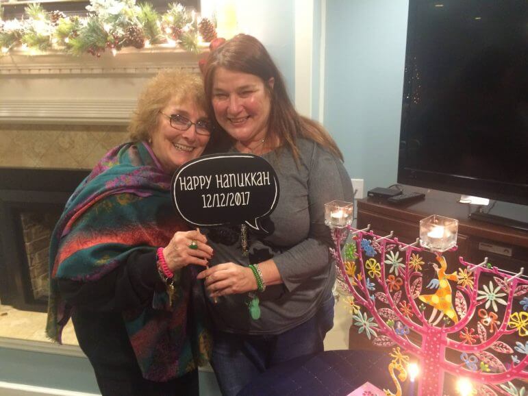 [CREDIT: Natalie Pirc] Naomi Fink Cotrone with a resident of Right at Home during a Hanukkah celebration at the home care facility.