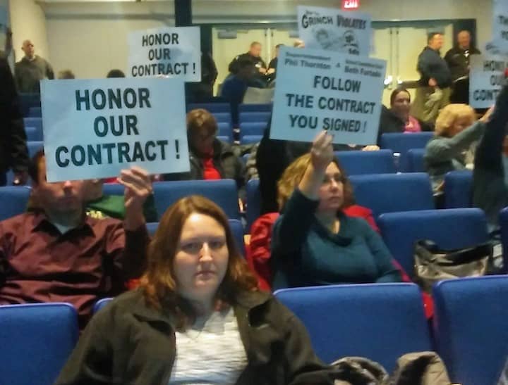 [CREDIT: Joe Seigel] Teachers inside Warwick Veterans School held signs demanding Warwick Public Schools honor an agreement to pay them back wages by Dec. 21.