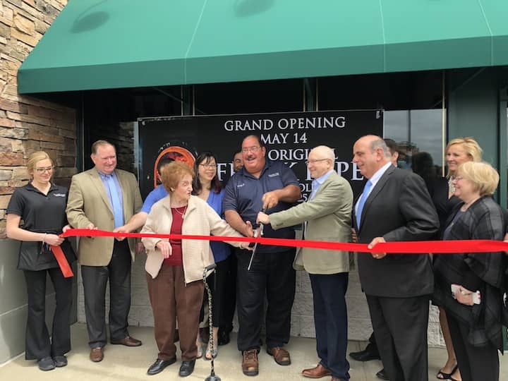 [CREDIT: Alyssa Stevens] Gary Bimonte, Grandson of Frank Pepe and Director of Quality Assurance & Training + incoming Mayor/City Council President Joseph Solomon celebrate the opening of Frank Pepe of Warwick with an official pizza cutting.
