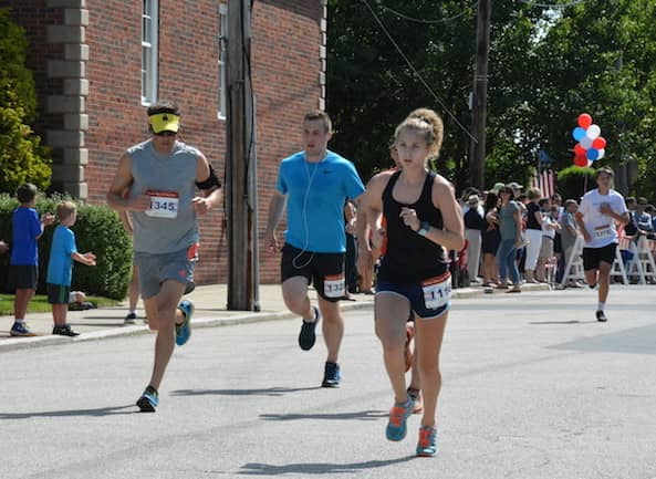 [CREDIT:Rob Borkowski] From left, Jeff Clare, 47, of Cranston, and Ana Caliri, 16, far right, of East Greenwich, near the finish line at the Gaspee Days 5K Saturday, June 10, 2018.