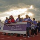 [CREDIT: Mary Carlos] Survivors of cancer march during a themed lap around West Warwick's High School track during the Relay for Life in 2017.
