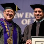 [CREDIT: Joe Giblin] 1. NEIT President Richard Gouse (left) presents an honorary doctor of humane letters to 2019 commencement speaker Chris Herren, in recognition of his work to help others during New England Tech commencement in Providence May 5, 2019.
