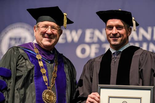 [CREDIT: Joe Giblin] 1. NEIT President Richard Gouse (left) presents an honorary doctor of humane letters to 2019 commencement speaker Chris Herren, in recognition of his work to help others during New England Tech commencement in Providence May 5, 2019.