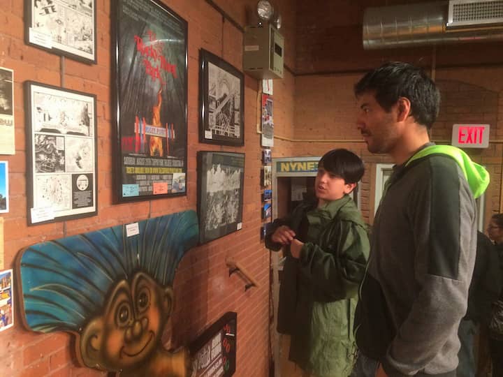 [CREDIT: Rob Borkowski] James Merida and his son, Jobe, peruse artwork from the “Remembering Rocky Point Park! exhibit at the Warwick Center for the Arts. 