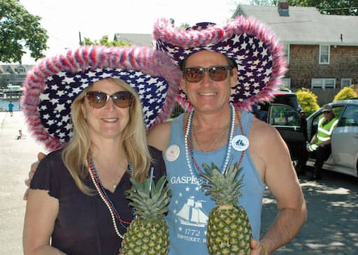 [CREDIT: Rob Borkowski] Laurie Hazard and Steve Berube are shaded from the sun and equipped with pineapple refreshments for the 2019 Gaspee Days Parade Saturday, June 8.