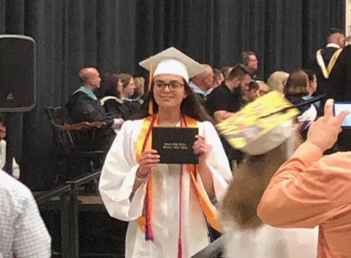 [Kim Wineman] Lauren Simpson proudly shows off her diploma at Pilgrim High's 2019 graduation ceremony. 