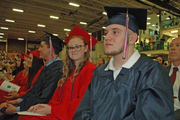 {CREDIT: Rob Borkowski] Front to back, Kyle Wright-Perry, Brittany Wysong, David Yabut, Rebecca Yaseen, and Jaquelin and Jennifer Zuniga wait during graduation at the CCRI field house June 6.