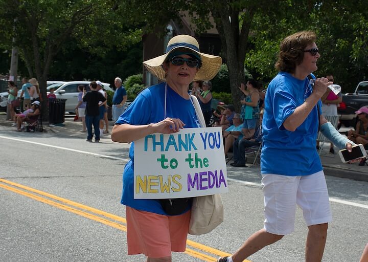 [CREDIT: Mary Carlos] Organizers of the Conimicut Apollo 11 parade carried signs thanking sponsors and contributors to the parade July 20, 2019.