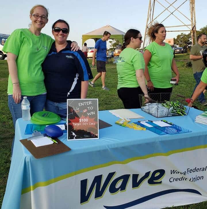 [CREDIT: Rob Borkowski] Movies in the Park, showing Spider-Man: Into the Spiderverse July 25 at Rocky Point Park, were sponsored by Wave Federal Credit Union. From left are Melissa Izzy and Cassandra Desjarlais, greeting the public for Wave.