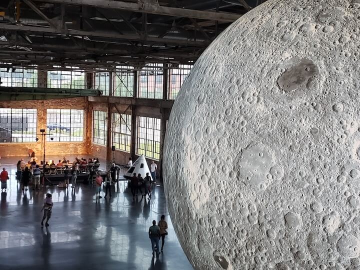 [CREDIT: Rob Borkowski] An enormous replica of the moon sits inside the Water Fire Arts Center, 475 Valley St., Providence, above a Warwick-crafted replica of the Apollo 11 command module. The exhibit runs through July 28.