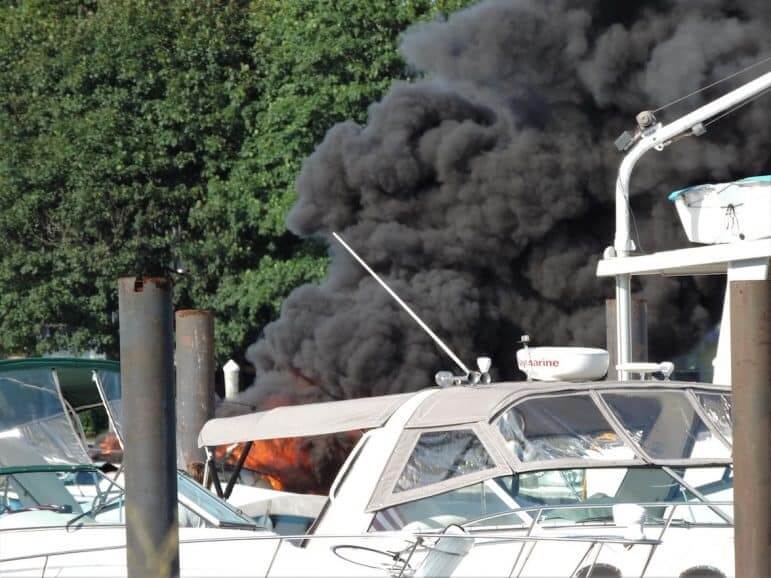 [CREDIT: Lincoln Smith] Black smoke from a boat fire Saturday at the Fair Winds Marina filled the sky with thick black smoke. 