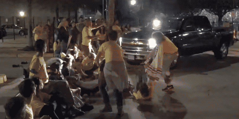 [CREDIT:Steve Ahlquist/UpriseRI] A Wyatt Center guard drives a truck into a crowd of seated protestors outside the facility Aug. 14.