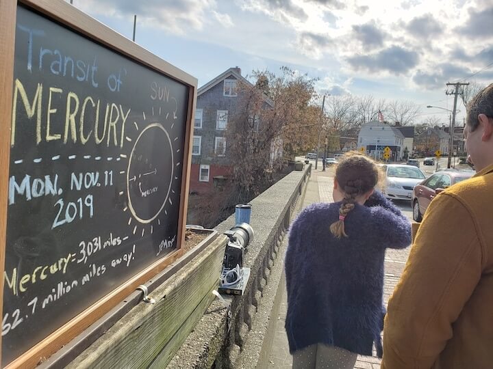 [CREDIT: Mary Carlos] Passers by got a look at Mercury crossing the Sun with Jason Major on the Pawtuxet River Bridge during the Transit of Mercury Nov. 11, 2019.