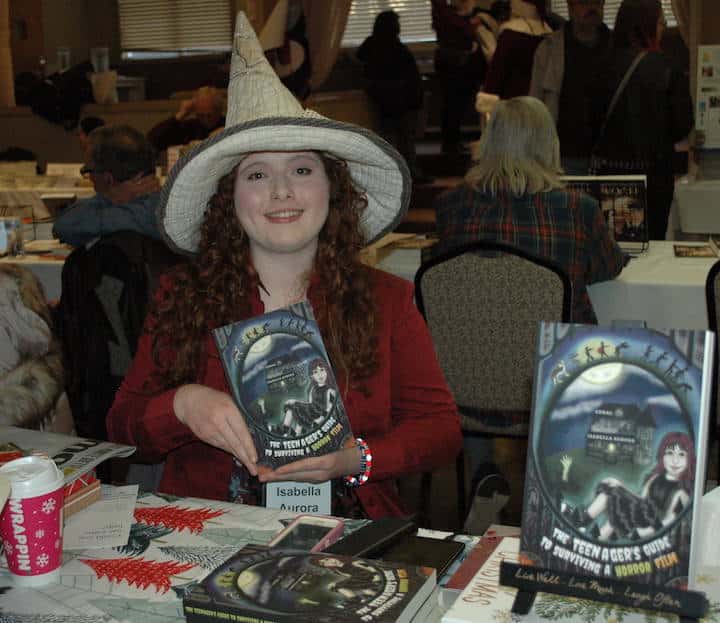 [CREDIT: Rob Borkowski] Author Cora Isabella Aurora with her book,"The Teenager's Guide to Surviving a Horror Film," at the RI Author Expo at Rhodes on the Pawtuxet.