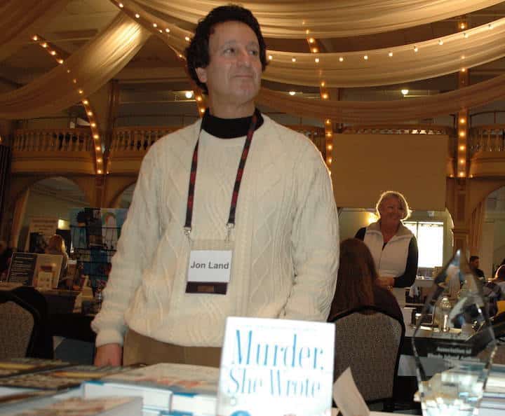 [CREDIT: Rob Borkowski] Jon Land at the RI Author Expo at Rhodes on the Pawtuxet, showing off his latest books, including "Murder, She Wrote," co-written with Jessica Fletcher.