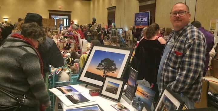 [CREDIT: Rob Borkowski] Mike Dooley with some of his photography prints at Crowne Plaza during Small Business Saturday.