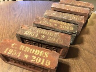 [CREDIT: Marc Berman] Bricks from the demolished Rhodes School have been stenciled as keepsakes for interested former faculty, staff and students of the closed school.