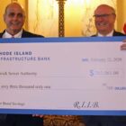 [CREDIT: RI Infrastructure Bank] Warwick Mayor Joseph J. Solomon accepted a check for $263,000 in savings from the Jeffrey R. Diehl, Executive Director and CEO of Rhode Island Infrastructure Bank, for the Warwick Sewer Authority Wednesday.