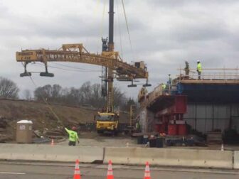 [CREDIT: Rob Borkowski] About 12 people worked atop the new Centerville Road bridge for Rte.95, where a North American Crane and Rigging crane moved a large cement finisher.