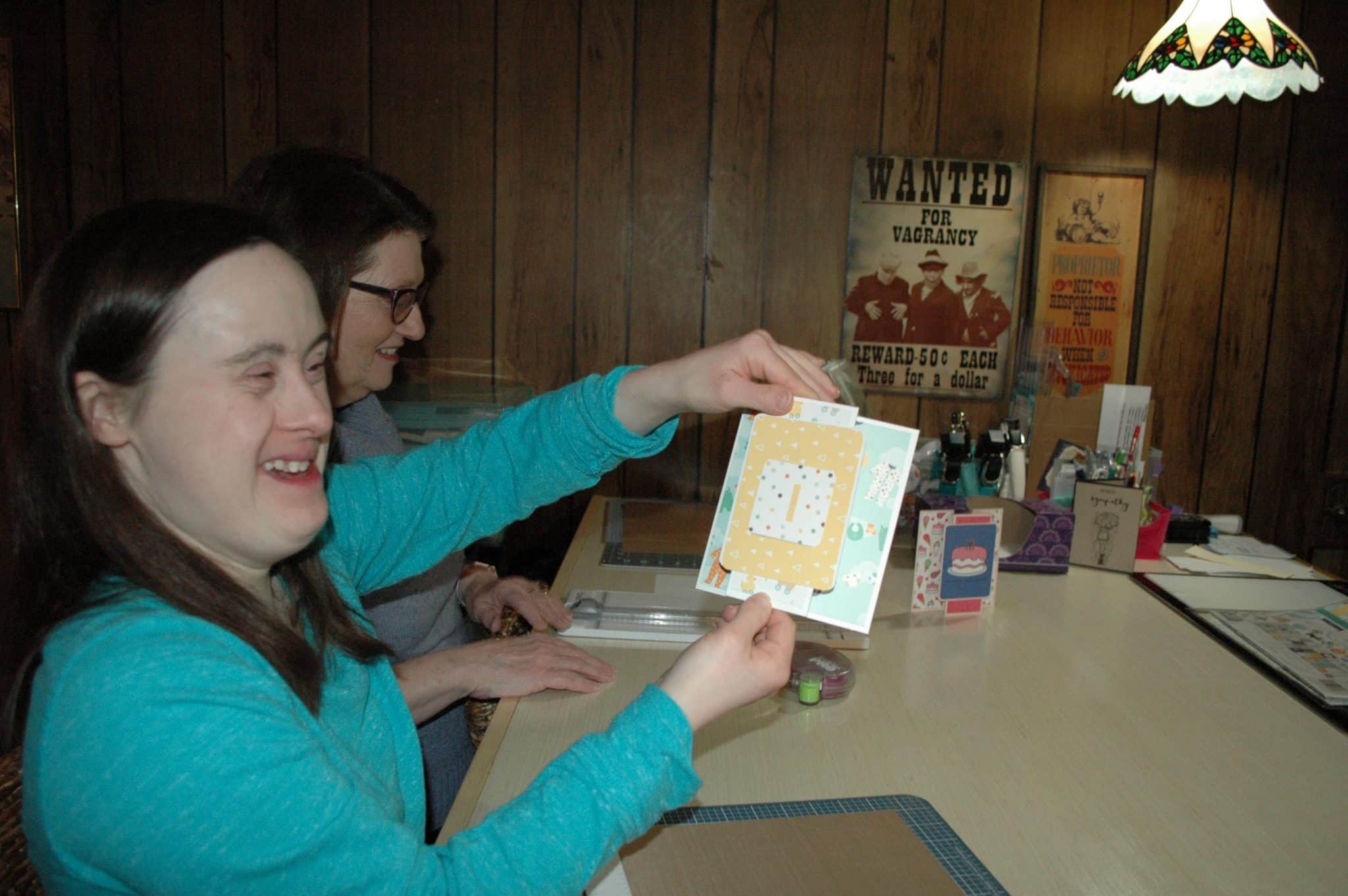 [CREDIT: Rob Borkowski] Katie Lowe, owner of Cheetah Greetings, shows off one of her hand-crafted greeting cards.