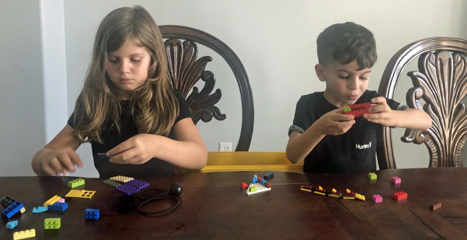 Liliana, 6 and Rocco, 4 from Houston, TX, work on a remote STEAM ship lesson in buoyancy from the Steamship Historical Society of America. They built a LEGO boat to test how things float while at home during the COVID-19 crisis.