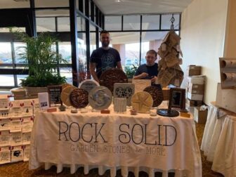 [CREDIT: Gail McCusker] From left, Ron Drake, a friend, and Nic Votolo man the Rock Solid Creations booth at Small Business Saturday in November 2019.