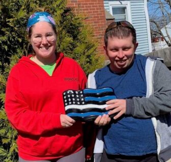 [CREDIT: Gail McCusker] Nic Votolato shows off one of the garden stones sold at Rock Solid Creations.