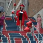 [CREDIT: Rob Borkowski] Tollgate 2020 graduate Megan Devlin descends the stairs at Toll Gate High with her family, diploma in hand.