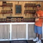 [CREDIT: Debbie Wood] Jason Wood, proprietor of We Be Jamming, at his shed/shop in Warwick on West Shore Road, with a wide selection of jams and spreads for sale.