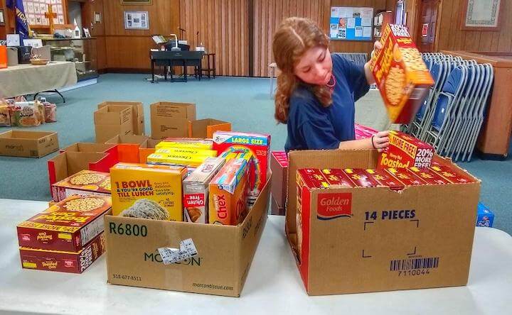 [CREDIT: Linc Smith] Emily McGuire packs the cereal from the Second Cereal Challenge for Westbay Marketplace.
