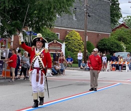 [CREDIT: Rob Borkowski] The Pawtuxet Rangers and Mace Bearer Stephen McCartney helped start off the 2021 Gaspee Day Parade. Here, they're presenting at the end of the route before the reviewing stand in Cranston on Broad Street.