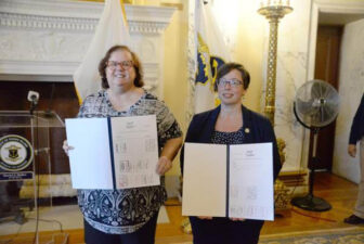 [CREDIT: Legislative Press and Public Information Bureau] Rep. Camille F.J. Vella-Wilkinson (D-Dist. 21, Warwick), left, and Sen. Melissa A. Murray (D-Dist. 24, Woonsocket, North Smithfield) are seen at today’s bill-signing ceremony in the Governor’s Reception Room at the State House.