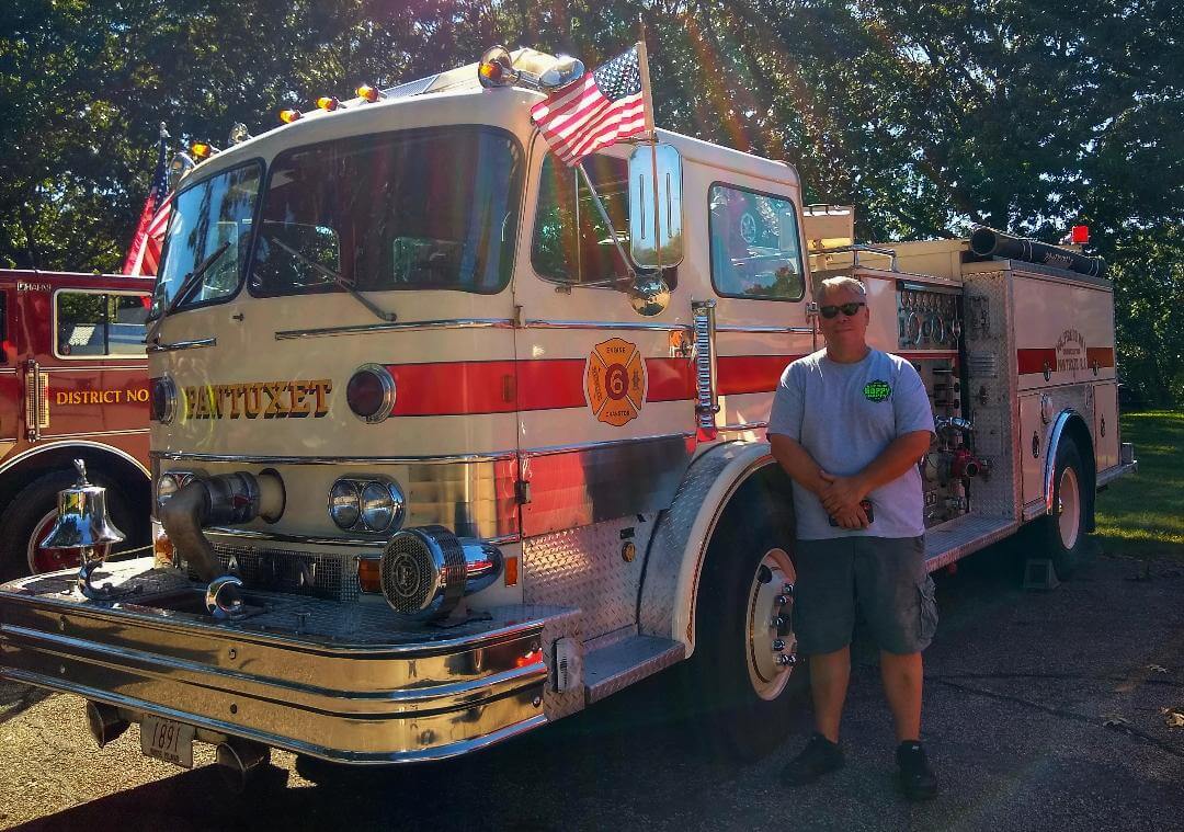 [CREDIT: Lincoln Smith] A Pawtuxet, 1972 Hahn. Standing beside it is Paul Shernan who is still listed as Captain of the fire company. Sherman posed during the Antique Fire Truck Show at the Masonic Youth Center Sept. 27, 2021.