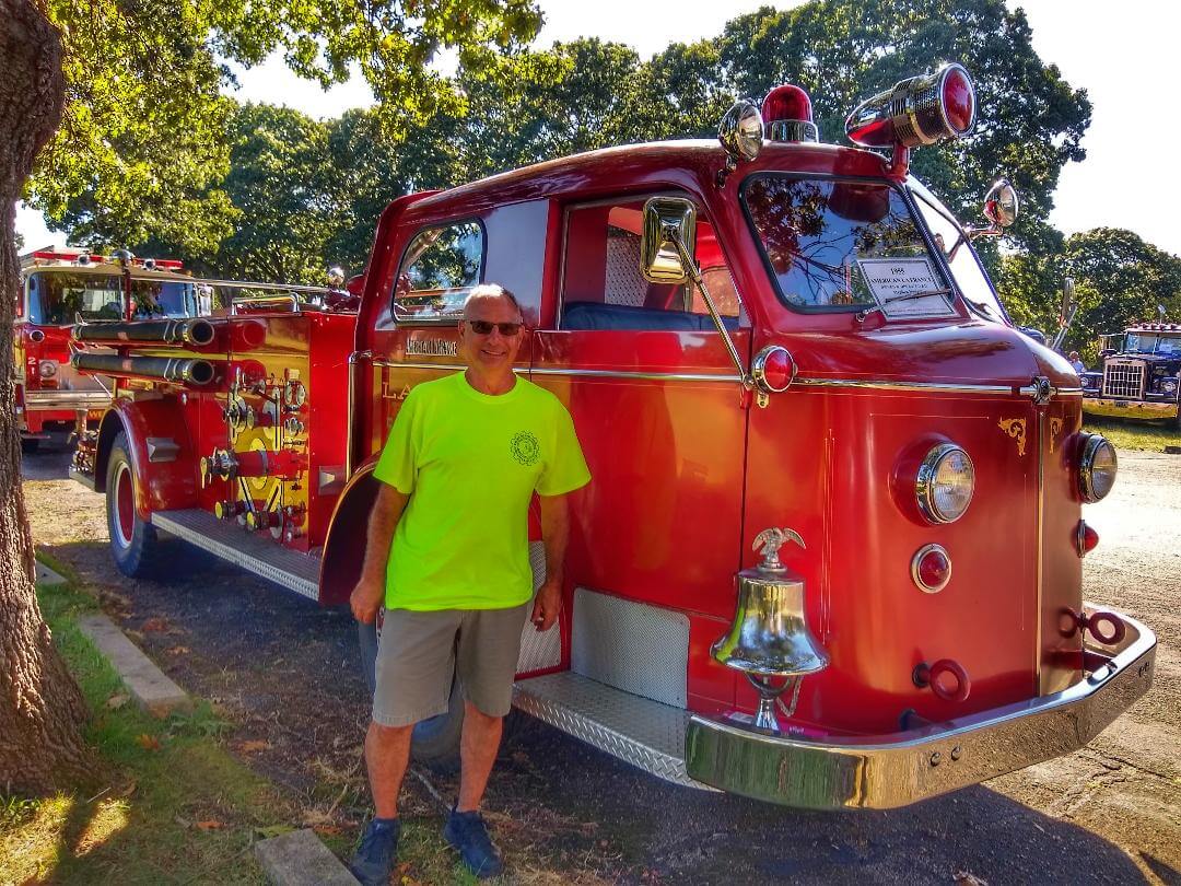 [CREDIT: Lincoln Smith] Stephen Nunes standing by his 1955 American LaFrance during the Antique Fire Truck Show at the Masonic Youth Center Sept. 27, 2021.