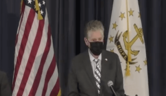[CREDIT: Gov. McKee's office] Rhode Islanders will need all COVID-19 protections together to put the pandemic behind us, Gov. McKee said, including masks and vaccinations.