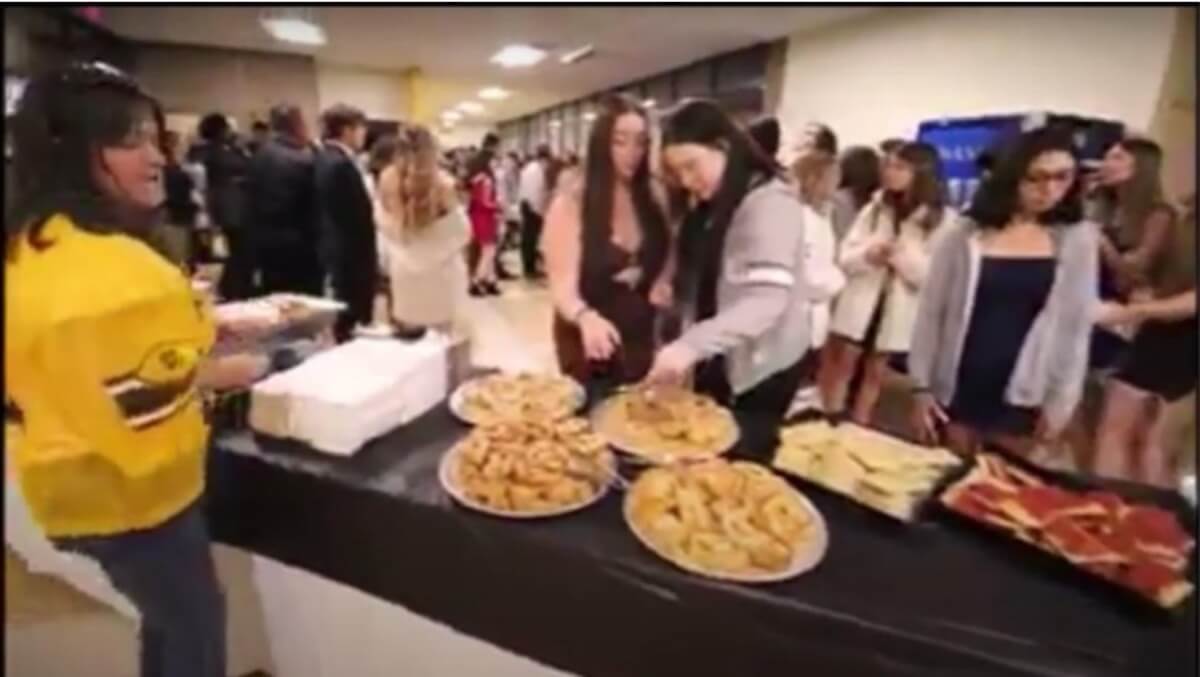 [CREDIT: Warwick Schools] A photo of students, unmasked, mingling indoors at a buffet Nov. 6 Pilgrim homecoming dance tied to a COVID-19 outbreak. Pilgrim School officials ignored several pandemic safety rules during the dance, including mask requirements and in failing to report food planning or distancing while eating. 