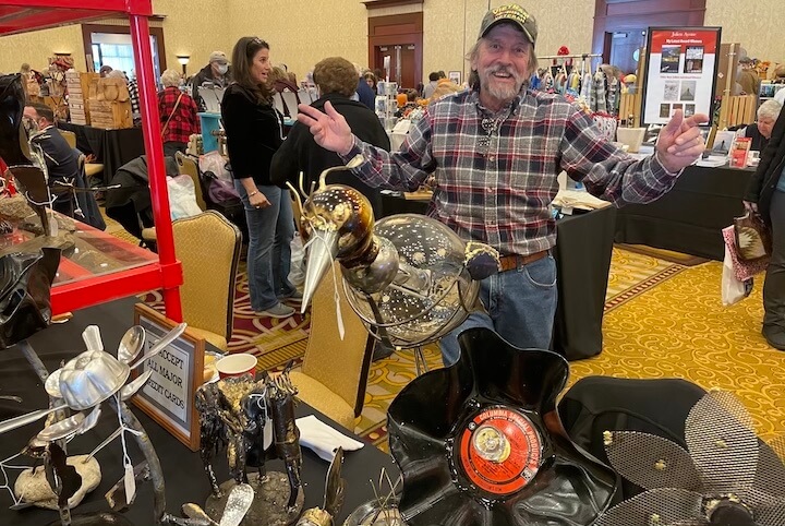 [CREDIT: Rob Borkowski] Richard Boudreau, owner of ARTicles metal sculptures, enjoying himself at Shop RI Nov. 26.