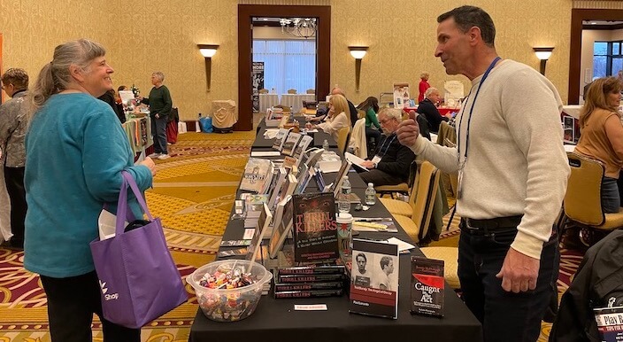 [CREDIT: Rob Borkowski] The RI Author Expo put readers in front of writers from every genre Saturday at Crowne Plaza Warwick. Here, author Paul Lonardo speaks with a customer about his books.