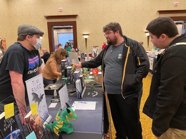 [CREDIT: Rob Borkowski] The RI Author Expo put readers in front of writers from every genre Saturday at Crowne Plaza Warwick. Here, Tim Baird, author of "Dragon of the Whites," speaks with, from left, Dan Raymond and Nat Cokely, about his work.